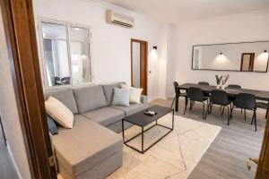 a living room with a couch and a table at Contemporary Chic with Terrace & Balcony in Madrid