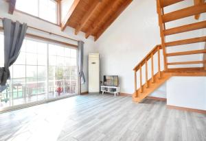 a living room with a staircase and a large window at Taean Mong And Mong Pension in Taean