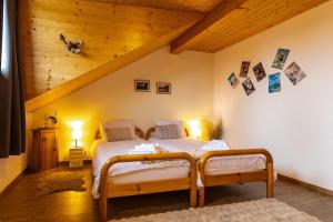 a bedroom with two twin beds in a attic at Hôtel Restaurant du Marchairuz in Le Brassus