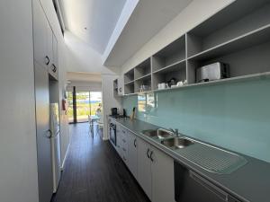 a kitchen with a sink and a counter top at Esperance Waterfront Apartment in Esperance