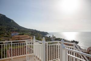 a view of the ocean from a white balcony at Seafront Apartment with Panoramic Rooftop Terrace in Paramonas