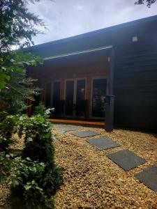 a building with a pathway leading to the front door at Woodbox Noszvaj in Noszvaj