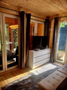 a living room with a tv on a dresser at Woodbox Noszvaj in Noszvaj