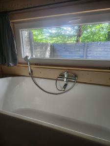 a hose is hooked up to a window at Woodbox Noszvaj in Noszvaj