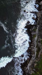 an aerial view of the ocean with waves at Villa Palmarcito in El Zonte