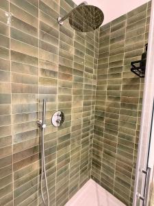 a shower with a shower head in a bathroom at Suite Agli Spaldi in Iesi +12 photos