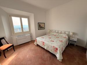 a white bedroom with a bed and a window at Suite Agli Spaldi in Iesi