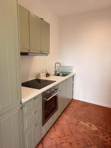 a kitchen with white cabinets and a sink at Suite Agli Spaldi in Iesi