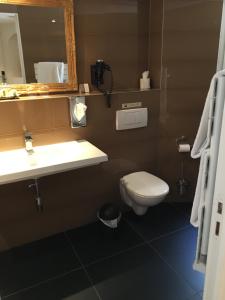 a bathroom with a toilet and a sink and a mirror at Hôtel La Villa Cannes in Cannes