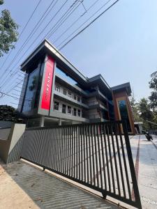 a building with a black fence in front of it at vaznest in Nilambūr