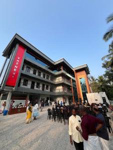 a group of people walking in front of a building at vaznest in Nilambūr
