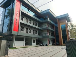 a building with a red sign on it at vaznest in Nilambūr