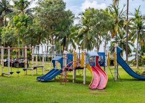 a playground with colorful slides in a park at Batam View Beach Resort in Nongsa