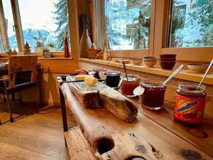 a wooden table with a loaf of bread on it at Alpenlodge in Zermatt
