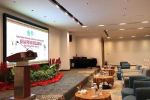 a podium in a room with chairs and a projection screen at Batam View Beach Resort in Nongsa +82 photos