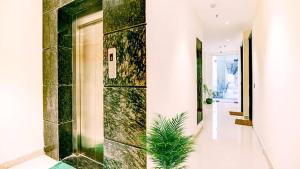 a hallway with a green and white tile wall at Hotel Near North View Park Zirakpur!! Best Budget Stay !!Free Parking!!Ambala Highway Chandigarh in Zirakpur