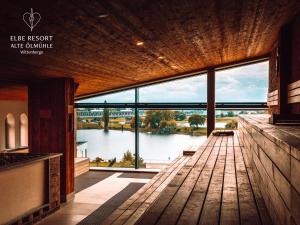 a large room with a view of the water at Hotel Elbe-Herz-Appartement in Wittenberge