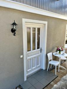 a door leading to a patio with a table at Ferienwohnung Am Pillersee in Sankt Ulrich am Pillersee