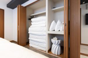 a room with a closet filled with towels at WeskiiHotel in Kanazawa +84 photos
