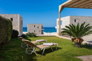 a table and chairs on the grass in front of a building at Diamond Dream 4 in Kalamaki