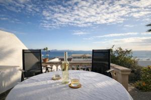 a table with a bottle of wine and two glasses at Auba Mar - Alcudia Sea View in Alcudia +3 photos