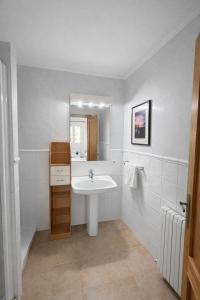 a white bathroom with a sink and a mirror at Auba Mar - Alcudia Sea View in Alcudia