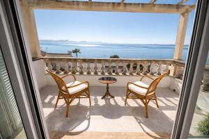 a view from a balcony with chairs and a table at Auba Mar - Alcudia Sea View in Alcudia