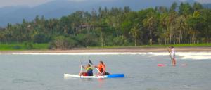 a group of people on a boat in the water at Puri Dajuma Beach Eco-Resort & Spa in Pulukan