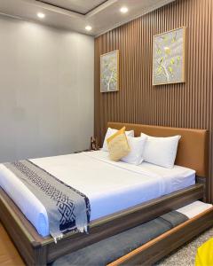 a bedroom with a large bed with white sheets at De Pointé Resort & Resto in Campaka +127 photos