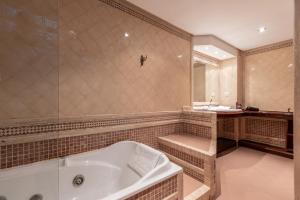 a large bathroom with a tub and a sink at CASA MIRAFLORES in Málaga +34 photos