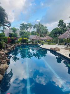 a swimming pool with blue water in a resort at Mirz accomodation FJ in Pacific Harbour