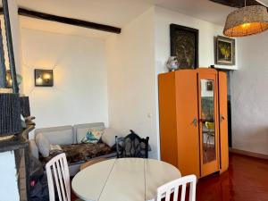 a living room with a table and a couch at Tour XIIIe siècle, vue mer, Cap Corse in Brando