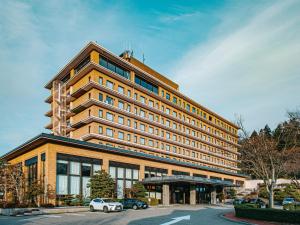 a large building with cars parked in front of it at Kanazawa Kokusai Hotel in Kanazawa