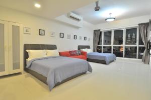 a bedroom with a bed and a couch and a window at Amazing KLCC View @ Regalia Residence in Kuala Lumpur