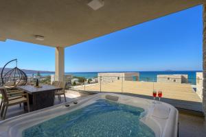 a hot tub in a house with a view of the ocean at Diamond Dream III in Kalamaki