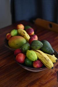 two plates of fruit on a wooden table at Oasis Simon's town cape town in Glencairn