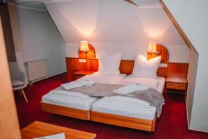 two beds in a small room with two lamps at Hotel Morgensonne in Augustusburg +34 photos