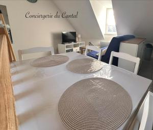 a table with two plates on it in a room at Murat - La petite maison Murataise in Murat