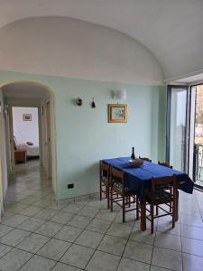 a dining room with a blue table and chairs at Dany House in Atrani +18 photos