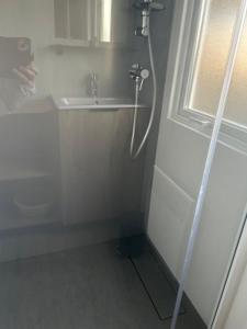 a shower in the corner of a bathroom with a sink at domaine de litteau in Litteau +4 photos