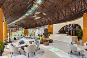 a rendering of the lobby of a resort with chairs and tables at Costamigo Phan Thiet, BW Premier Collection in Phan Thiet