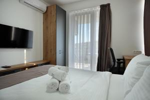 a hotel room with a bed with towels on it at Lakeview Apartments in Veles +69 photos