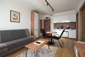 a living room with a couch and a table at Lakeview Apartments in Veles