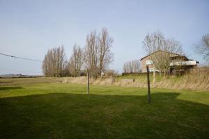 two poles in the middle of a field with a building at England 5 in Nordstrand