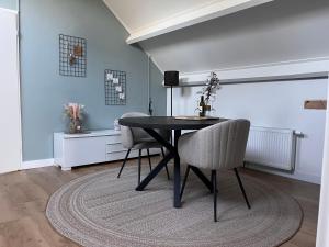 a dining room with a table and two chairs at Hei-d-Away in Otterlo +13 photos