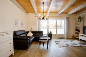 a living room with a couch and a table at Hus Utspann in Nordstrand