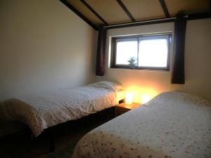 a bedroom with two beds and a window at Zeepolder I 129 in De Haan