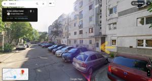 a street with a row of cars parked next to buildings at Mazepa 2 You in Galaţi