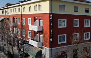 a building with white windows and red brick at Hotel Bel Ami Tirana in Tirana