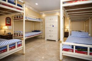a bedroom with three bunk beds in a room at Megha Resort , Hampi in Hampi
